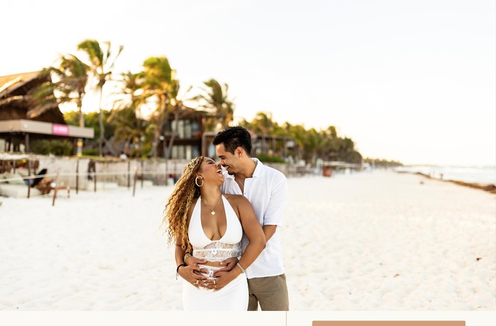 The newlyweds kiss during their seaside session